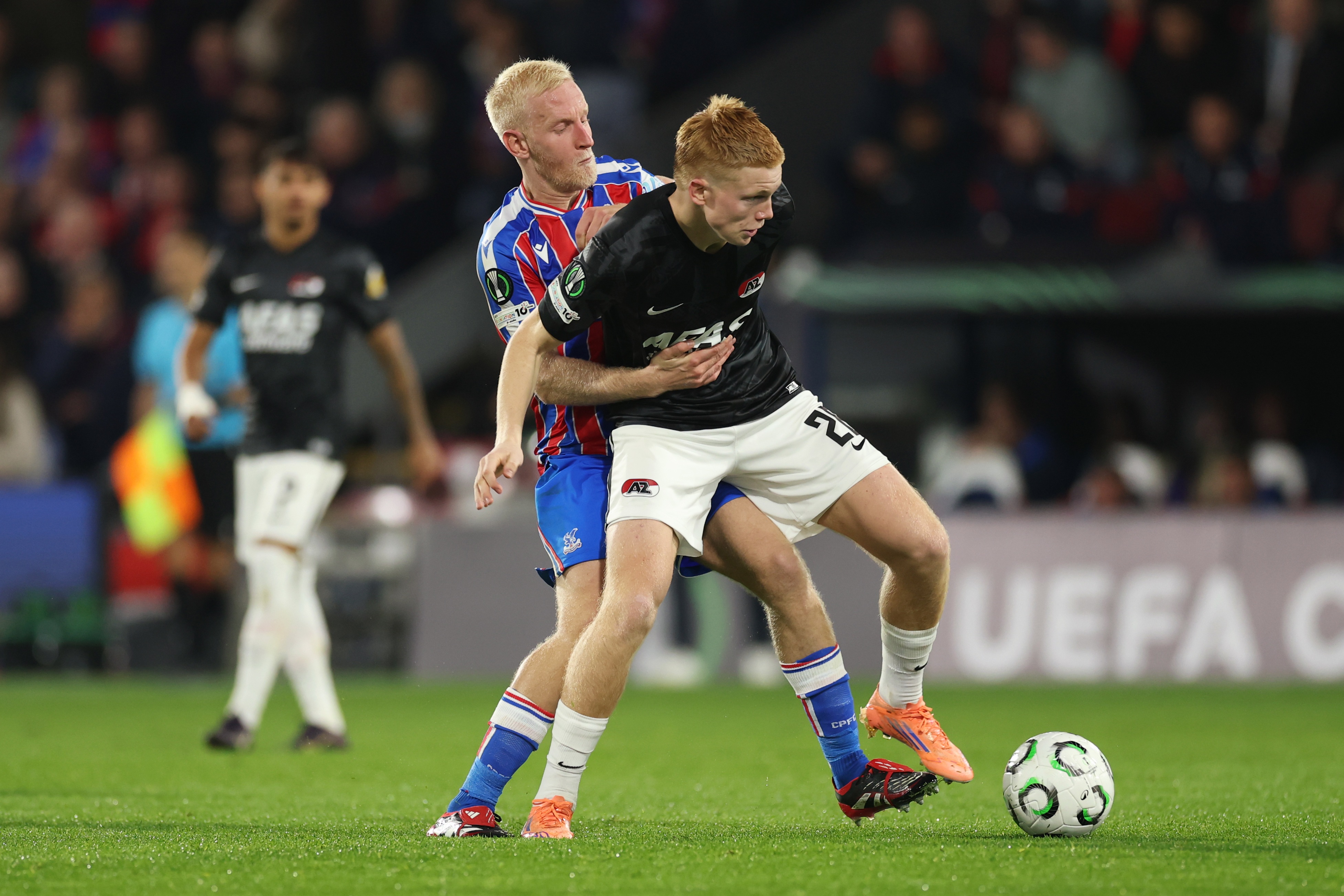 Will Hughes grapples with Kees Smit for possession of the ball.