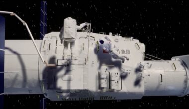 A large white spacecraft with an astronaut in a white spacesuit hanging off the side