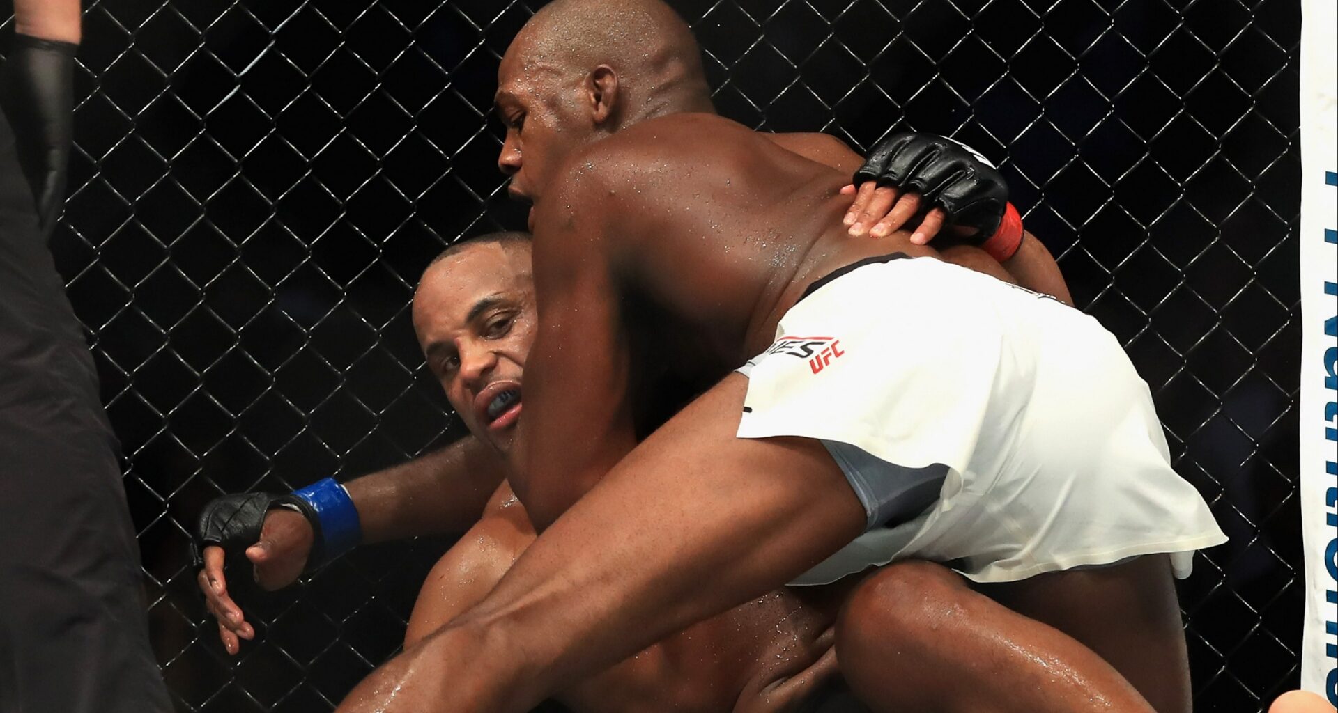 Jon Jones grapples with Daniel Cormier during their fight at UFC 214