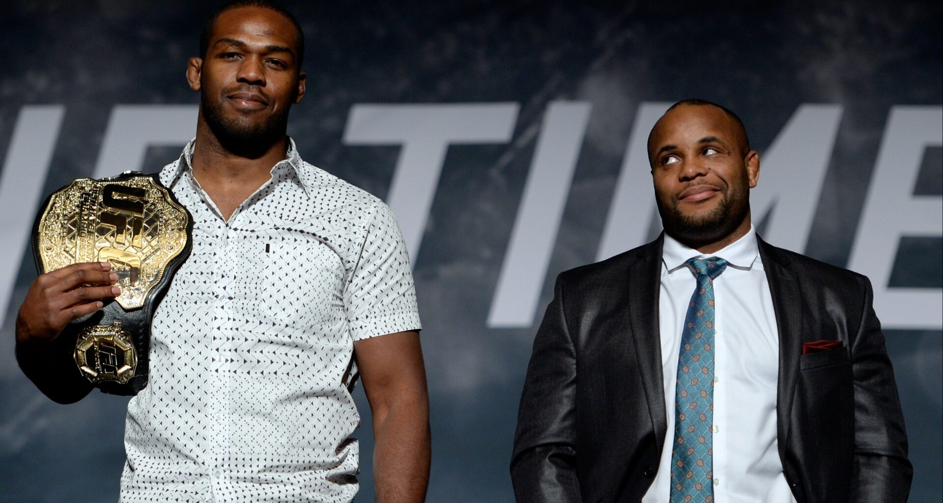 Daniel Cormier and Jon Jones pose on stage after a UFC press conference