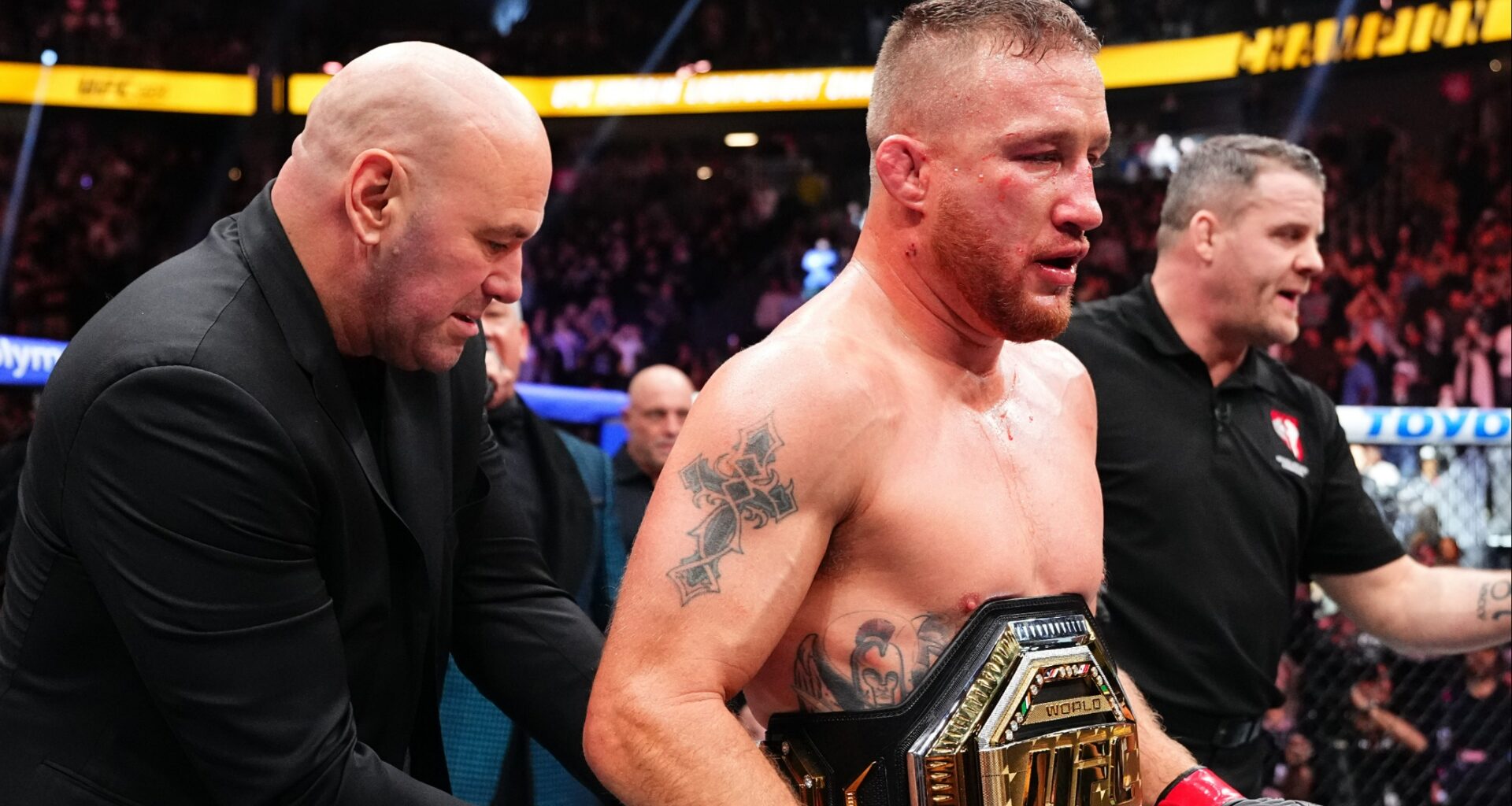 Justin Gaethje gets a UFC belt wrapped around his waist by Dana White at UFC 324