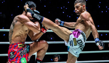 Iranian striker Mohammad Siasarani kicks "Smokin" Jo Nattawut