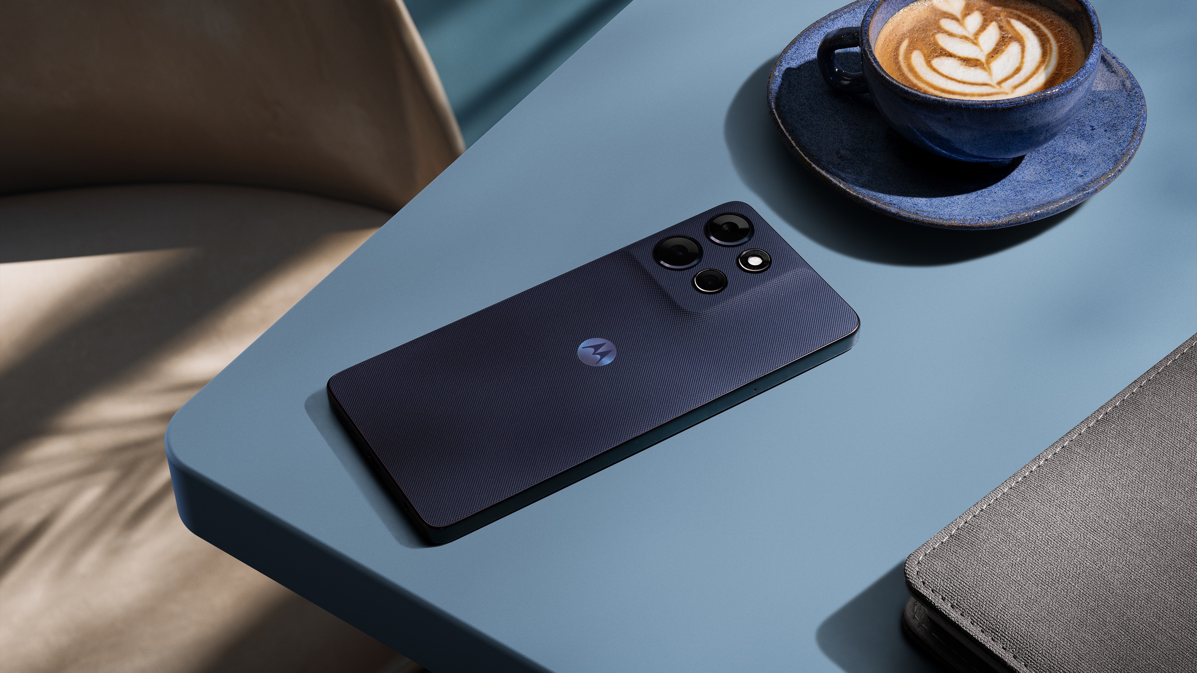 The Motorola G Power 2026 in an evening blue color beside a coffee.