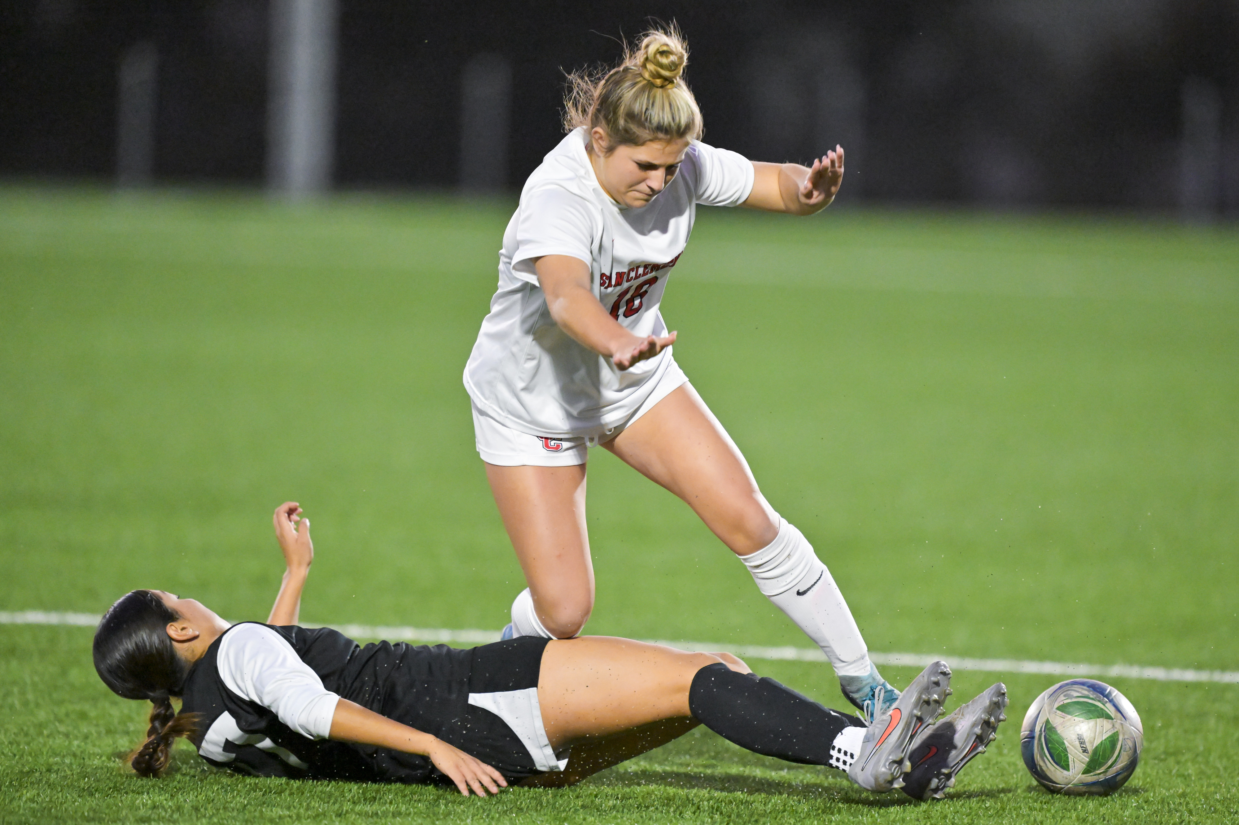 Chloe Miller (18) of San Clemente trips over Shiloh Aquino...