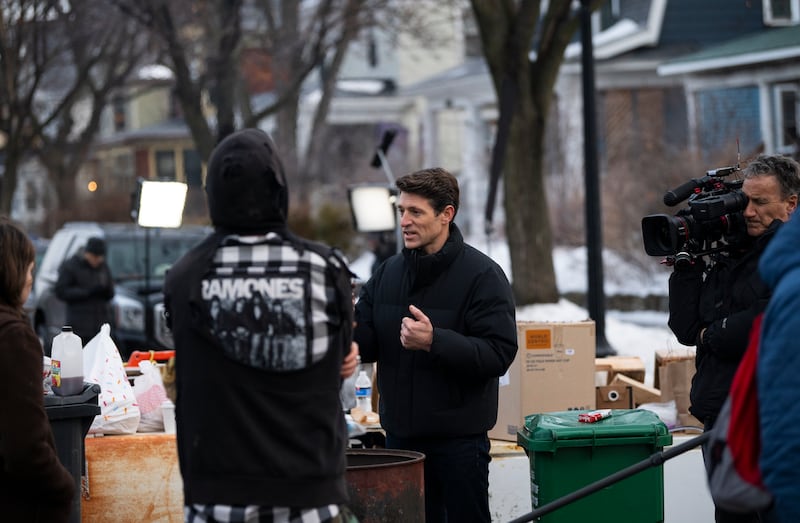 CBS News anchor Tony Dokoupil (C) interviews people near the site where Renee Nicole Good was shot and killed on January 08, 2026 in Minneapolis, Minnesota.