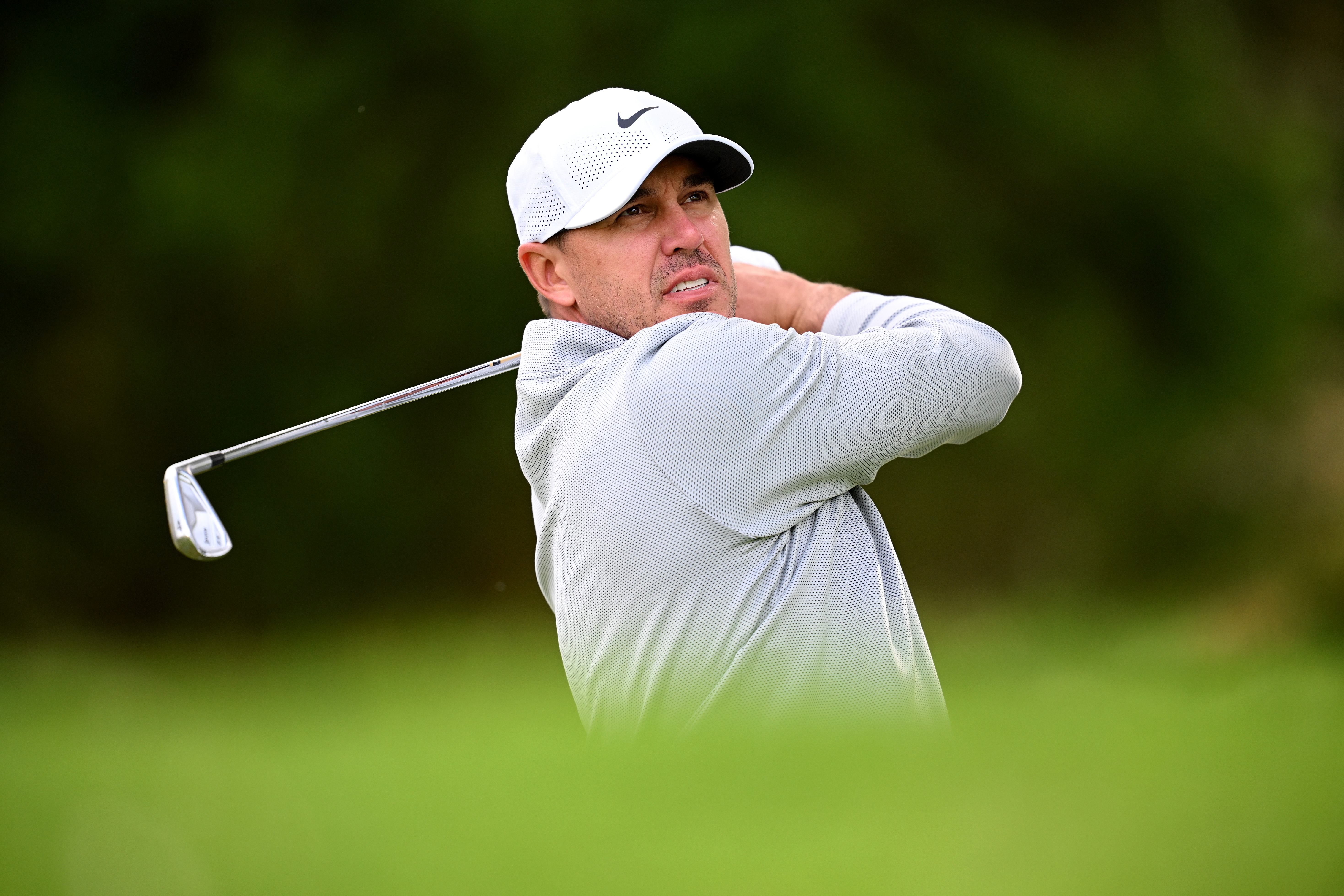 Brooks Koepka hits an iron shot