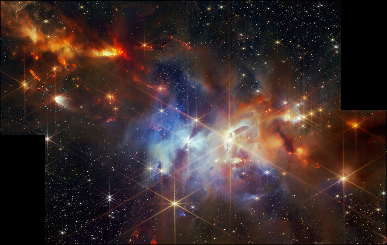 A young star-forming region is filled with wispy orange, red, and blue layers of gas and dust. At center-left, a larger star is circled. It has prominent diffraction spikes and an arc of white at right.