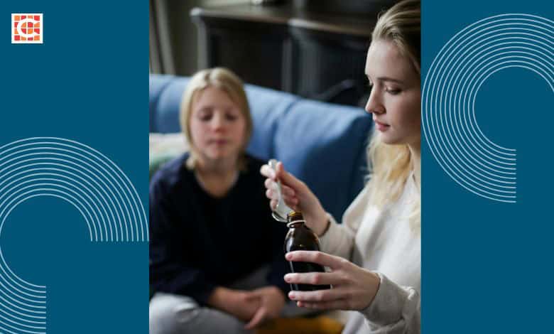 A mother gives her child medicine.