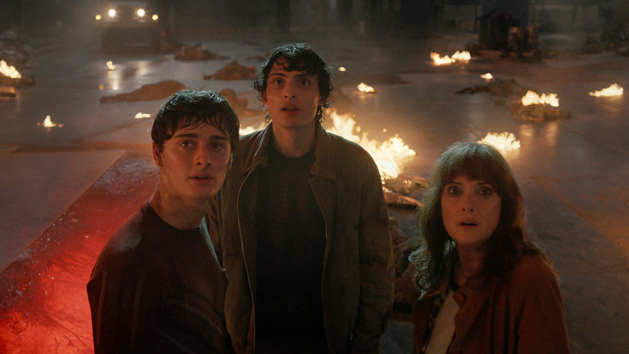 (L to R) Noah Schnapp as Will Byers, Finn Wolfhard as Mike Wheeler, and Winona Ryder as Joyce Byers in Stranger Things: Season 5.