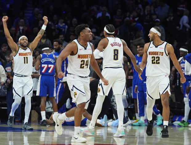 From left, Denver Nuggets players Bruce Brown, Jalen Pickett, Peyton Watson and Zeke Nnaji celebrate after defeating the 76ers in overtime Monday in Philadelphia. (AP Photo/Matt Rourke)