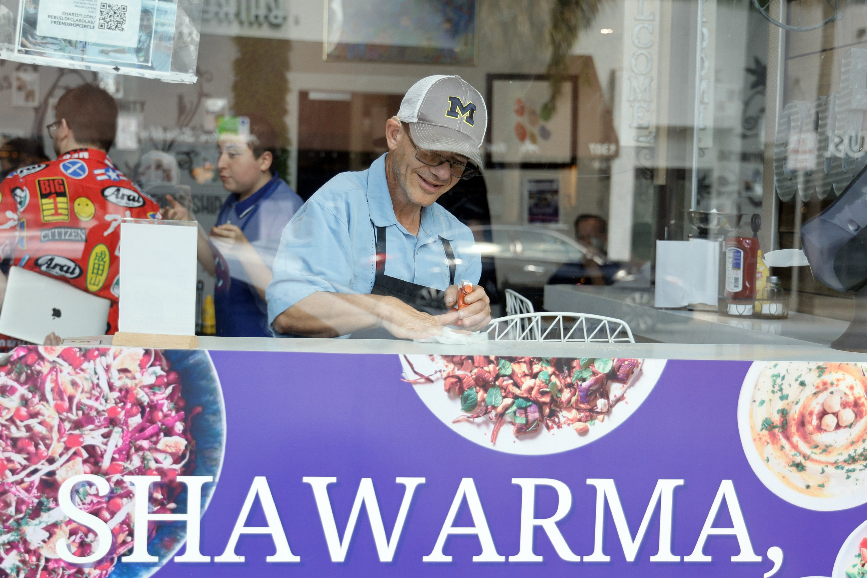 Randy Kugler cleans a countertop inside The Friendship Grill, which...