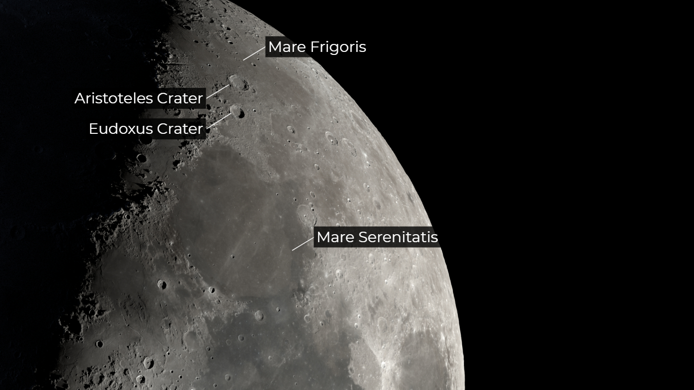 A section of the moon is pictured against a black sky, with the locations of the Aristoteles and Eudoxus craters labelled close to the line separating night from day, known as the "terminator".