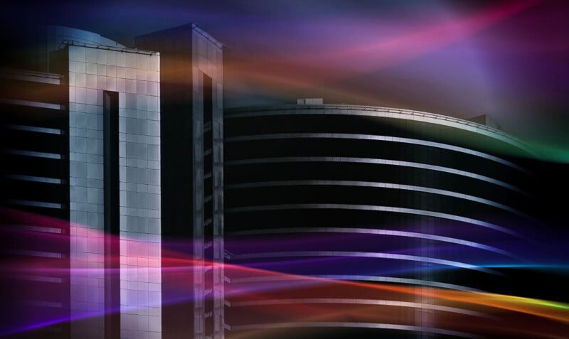 Modern building with curved and straight sections, illuminated by soft, colorful streaks of light against a dark, dramatic sky. The lighting creates a futuristic and abstract atmosphere.