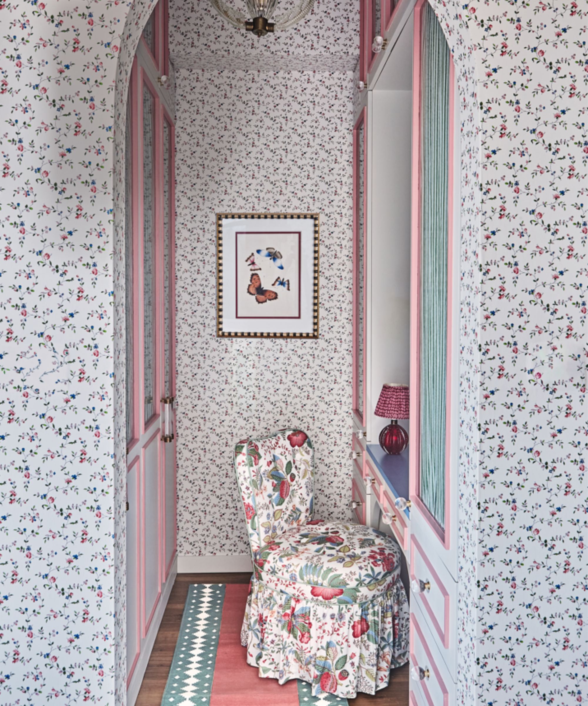floral master bedroom with a four poster bed and a small dressing room
