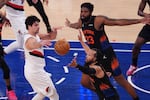 Portland Trail Blazers' Deni Avdija, left, passes away from New York Knicks' Jalen Brunson and Donovan Clingan, right, during the second half of an NBA basketball game Friday, Jan. 30, 2026, in New York.