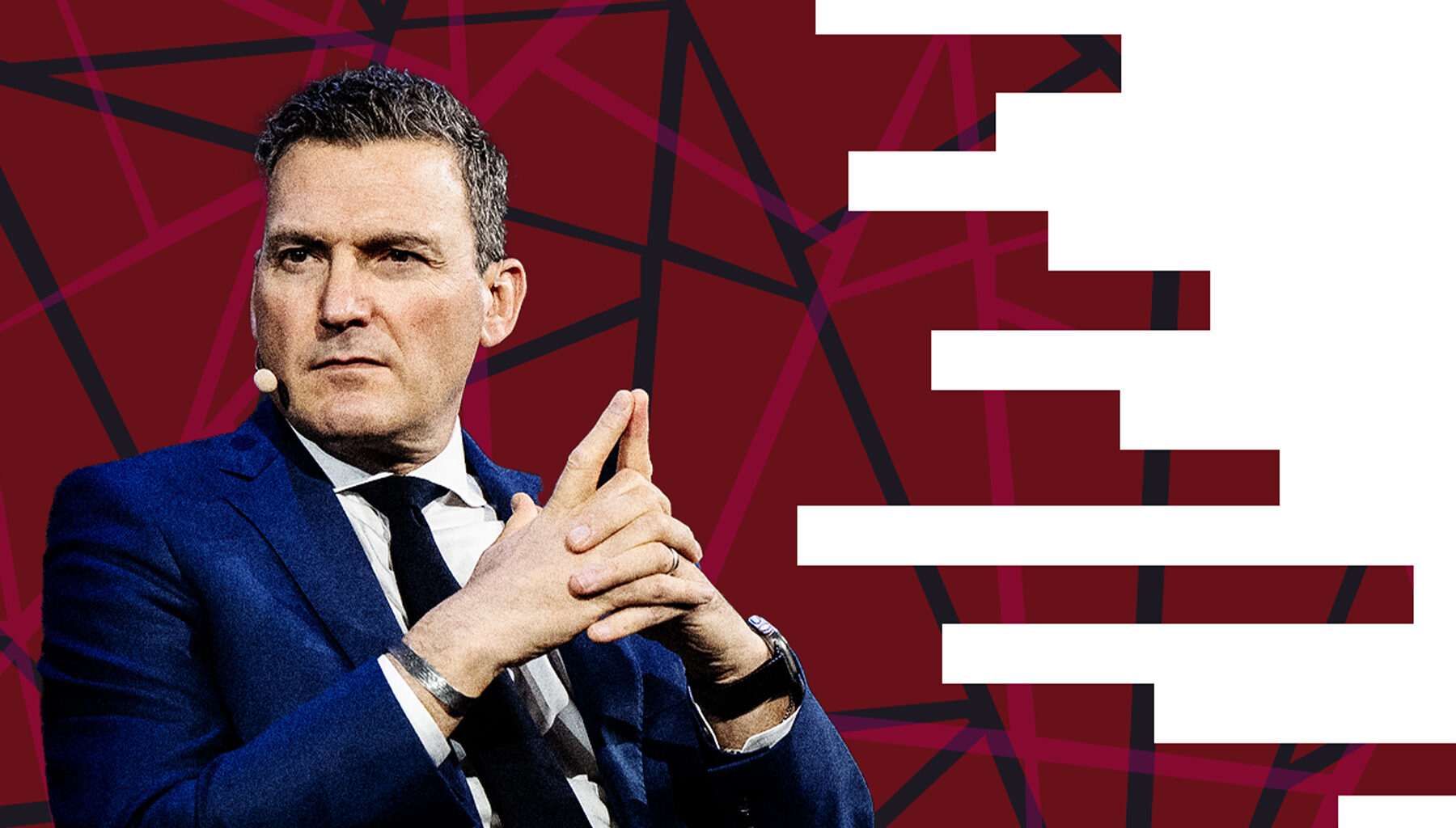 Photo of Evan Solomon against a red background.