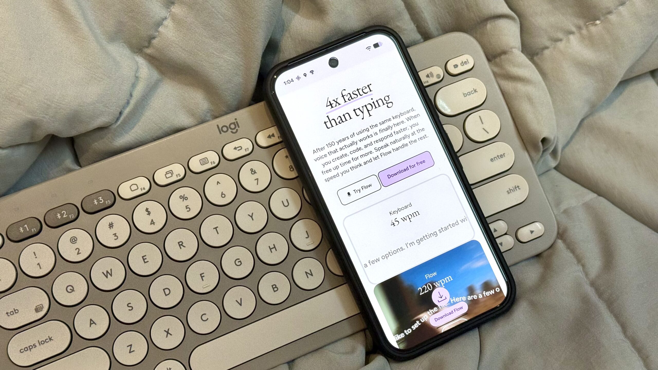 Wispr Flow AI voice dictation app's website open on a Pixel resting on a Logitech keyboard