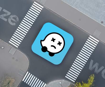 A street seen from above with the Waze logo showing a dead expression.