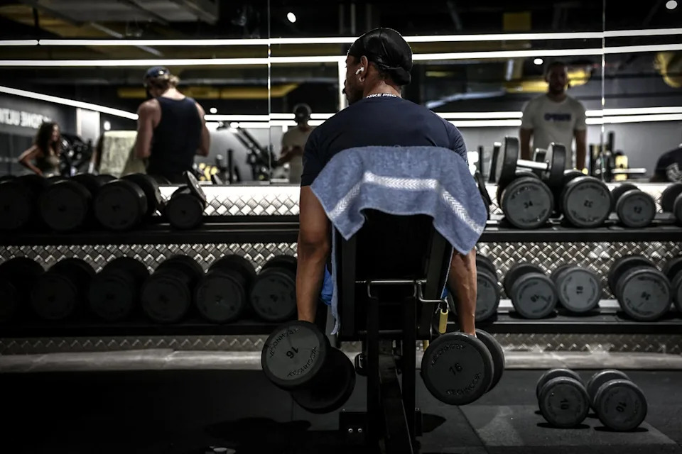 A man lifts weights during a workout (AFP via Getty)