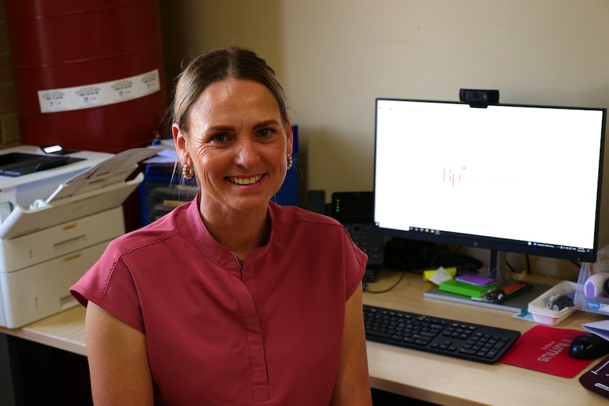 Skye Bradford sitting at her desk 