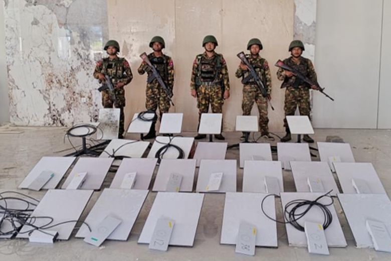 In this image provided by the Myanmar military on October 19, 2025, soldiers stand next to Starlink satellite devices as they seize KK Park online scam center in Myawaddy township, Karen state, Myanmar.