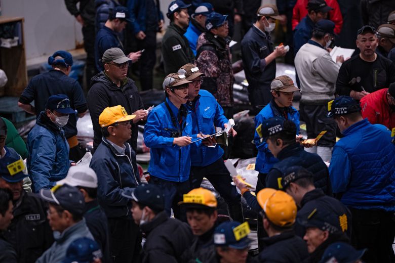 Wholesalers and buyers take part in the New Year's tuna auction at Toyosu fish market in Tokyo, on January 5, 2026.