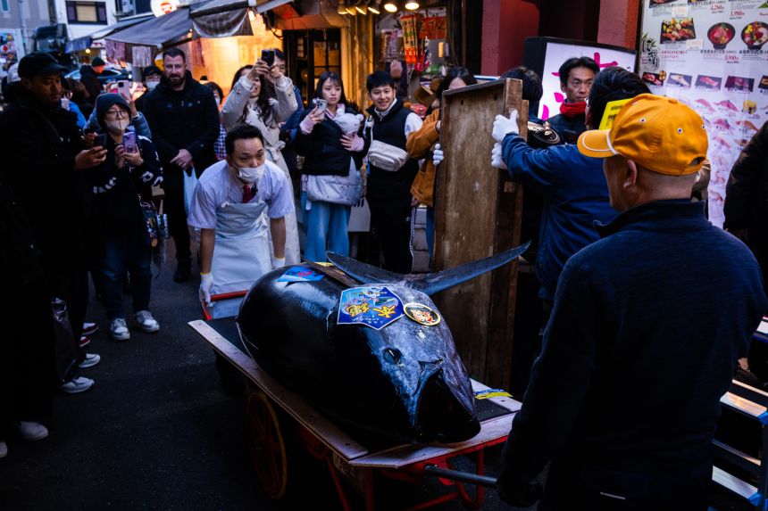 A bluefin tuna that won the highest bid at the annual New Year auction is carried to a Sushi Zanmai restaurant in Tokyo, on January 5, 2026.