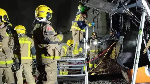 Catalonian fire service Fire crews inspect the wreckage of a train in Catalonia