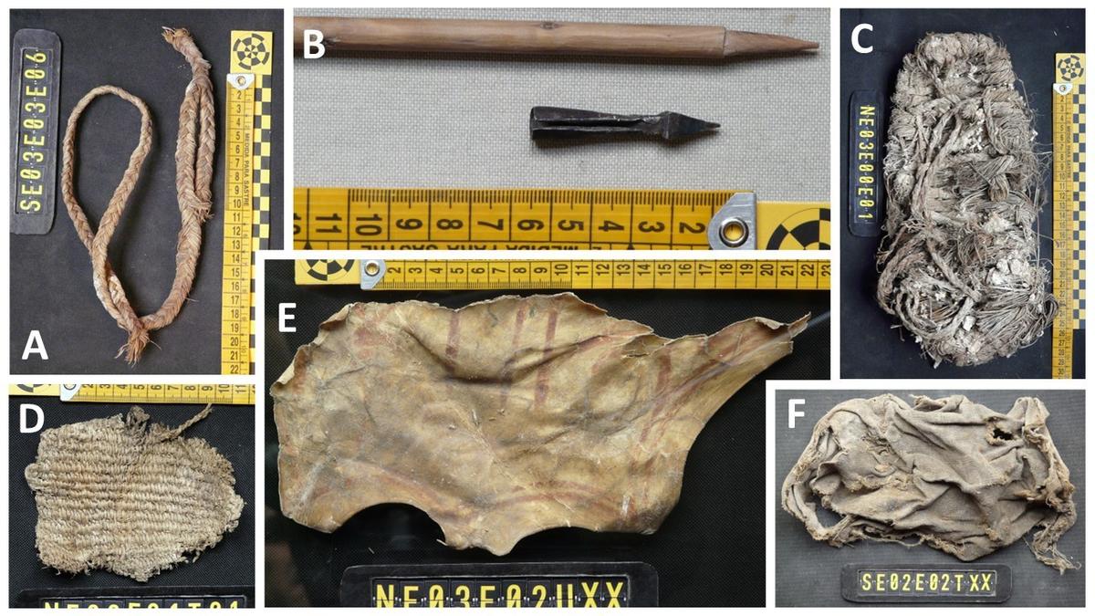Among the craft objects in the nests of bearded vultures, part of a slingshot stood out, a fragment of basketry, a piece of sheep leather with painted red lines and, surprisingly, a crossbow arrow, which the bird may have used as a nest material or collected from a prey. A composite image shows the different objects labeled. A: slingshot, B: crossbow arrow, C: grass sandal, D. Woven basket fragment, E: Leather scrap with red lines, F: a dirty, ragged cloth.