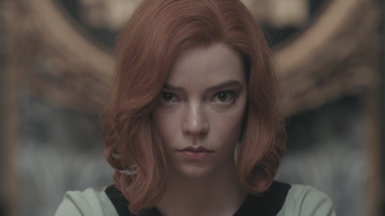 Anya Taylor-Joy as Beth Harmon staring into the camera in The Queen's Gambit