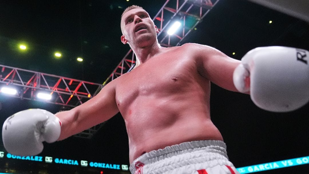 Poland's Damian Knyba, left, punches Joey Dawejko during the seventh round of a heavyweight boxing match Saturday.