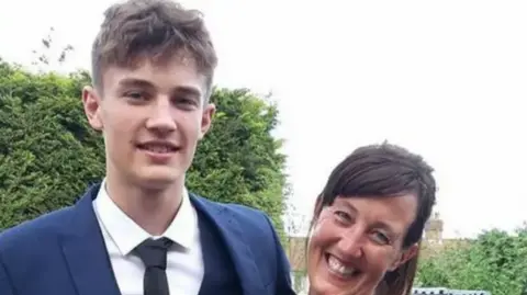 Kim Webster Kim and her late son William are photographed in a garden.  William is wearing a suit and tie.