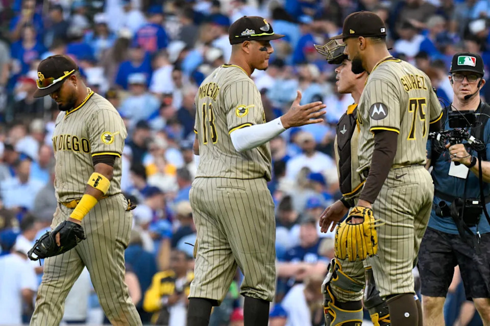 Oct 1, 2025; Chicago, Illinois, USA; San Diego Padres relief pitcher Robert Suarez (75) celebrates with teammates after the final out for the win against the Chicago Cubs in the ninth inning during game two of the Wildcard round for the 2025 MLB playoffs at Wrigley Field. Mandatory Credit: Matt Marton-Imagn Images
