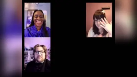 Lewis Relfe A Zoom camera set up with Lewis Relfe in the bottom left corner. The officiant is in the top left and Ameila Relfe on the right. She is holding her hand up to her camera showing the wedding ring following their marriage.