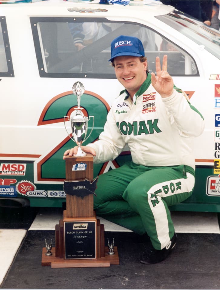 Ken Schrader poses with a trophy and car after winning the Clash.