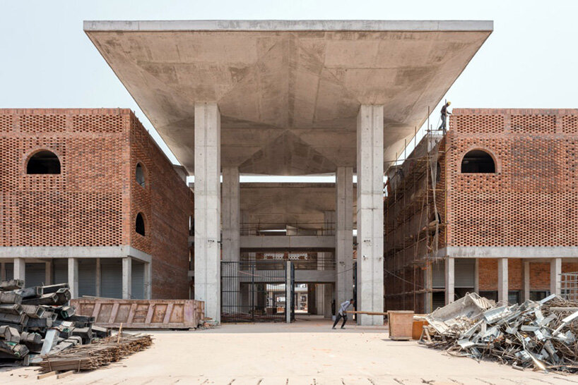 concrete canopies and porous brick walls form central market redevelopment in congo