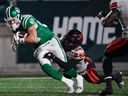B.C. Lions defensive back Robert Carter Jr.  tackles Saskatchewan Roughriders receiver Joe Robustelli during CFL West Division Final in Regina, on Saturday, November 8, 2025.