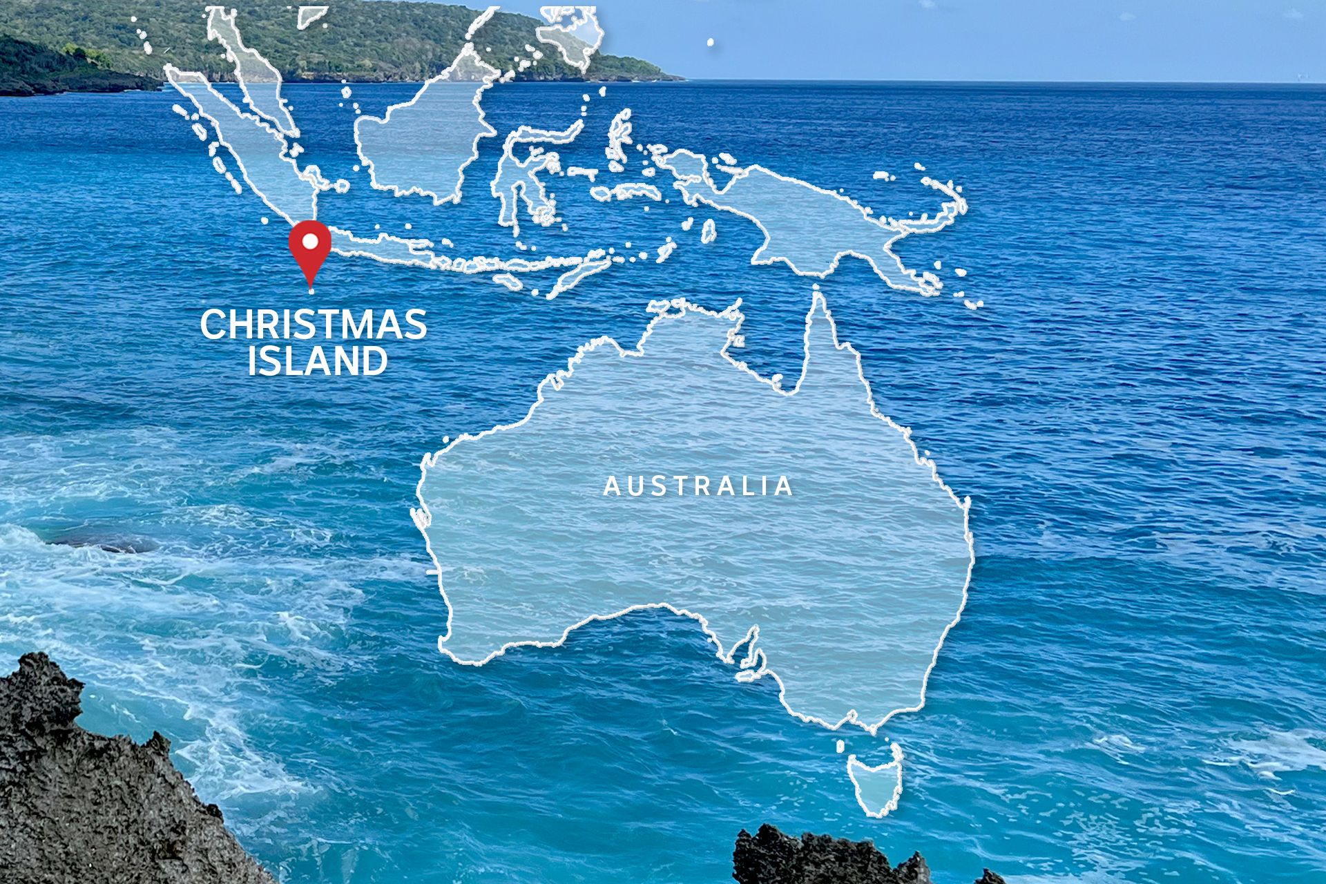 A map with Christmas Island marked in relation to Australia, superimposed over a picture of the ocean.