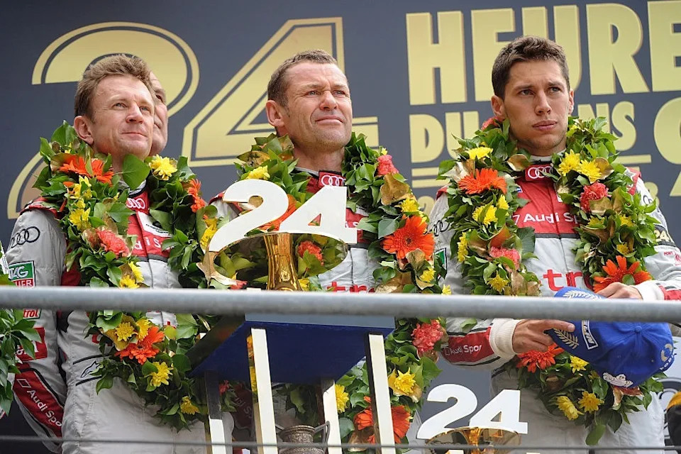 Allan McNish (left, with Tom Kristensen and Loic Duval) claimed his third Le Mans victory in 2013
