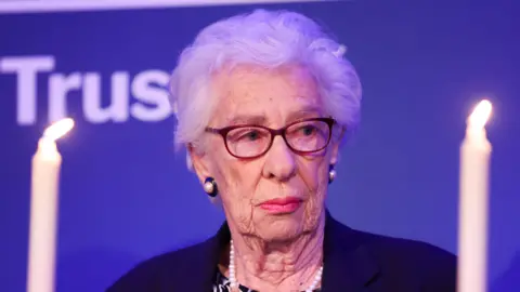 AFP via Getty Images Eva Schloss MBE, step-sister of Anne Frank and Honorary President of the Anne Frank Trust UK takes part in a candle lighting ceremony during a reception to mark Holocaust memorial day