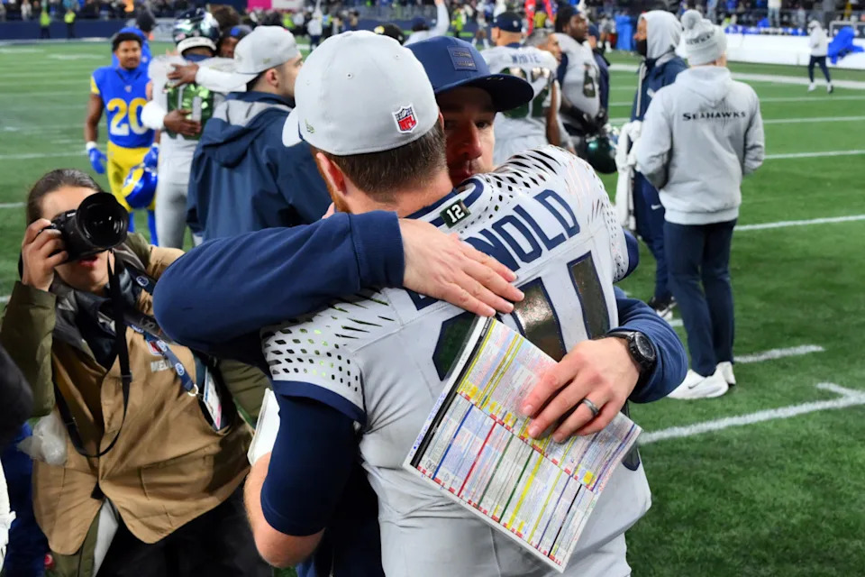 Seattle Seahawks quarterback Sam Darnold (14) hugs offensive coordinator Klint Kubiak at Lumen Field.Steven Bisig-Imagn Images