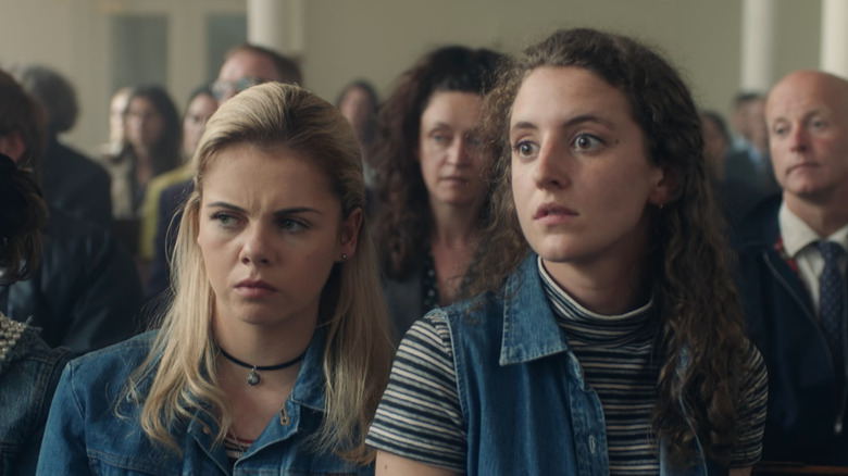 Erin (Saoirse-Monica Jackson) and Orla (Louisa Harland) in church in Derry Girls