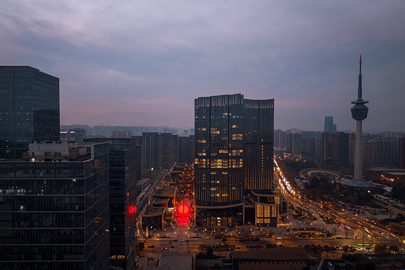 SpY's monumental divided sphere installation illuminates xi’an in bright red light