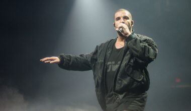 Drake performing on stage wearing all black