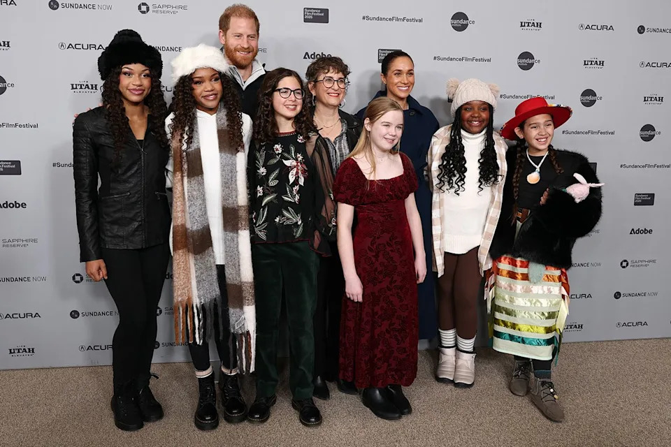 Cindy Ord/Getty Prince Harry, Alysa Nahmias and Meghan Markle pose with cast and crew at the 