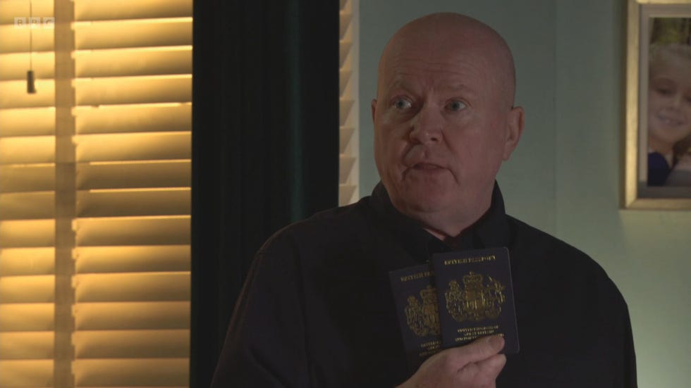 eastenders phil mitchell holding two passports