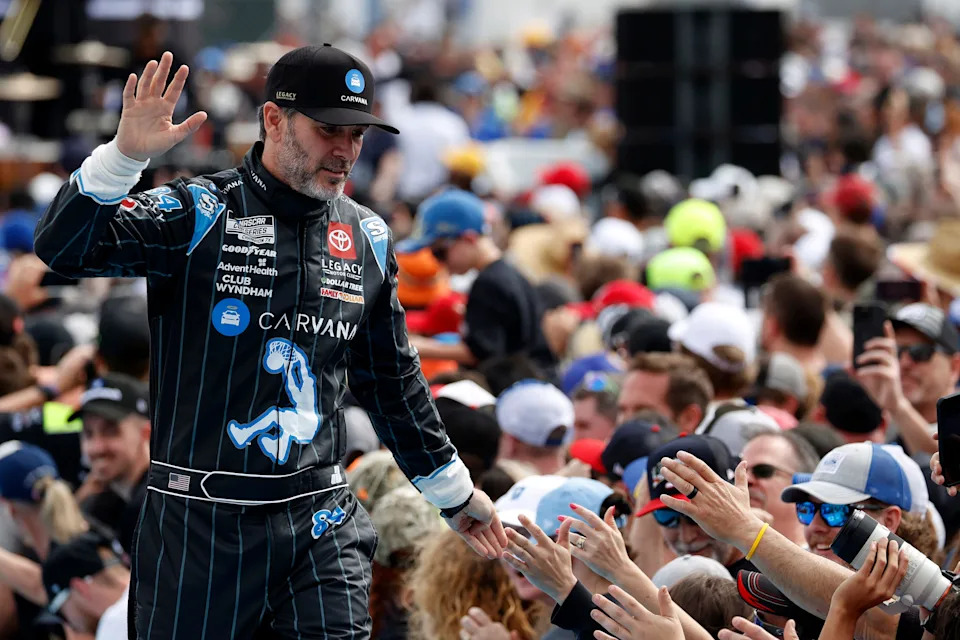 NASCAR Cup Series driver Jimmie Johnson (84) walks onto the driver introduction stage to greet fans before the 2025 Daytona 500 at Daytona International Speedway.