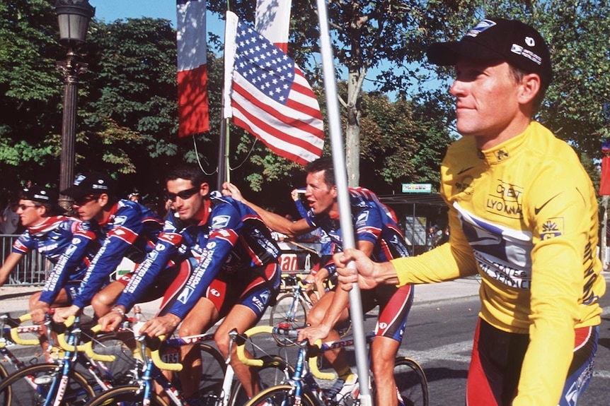 Lance Armstrong holds a flag