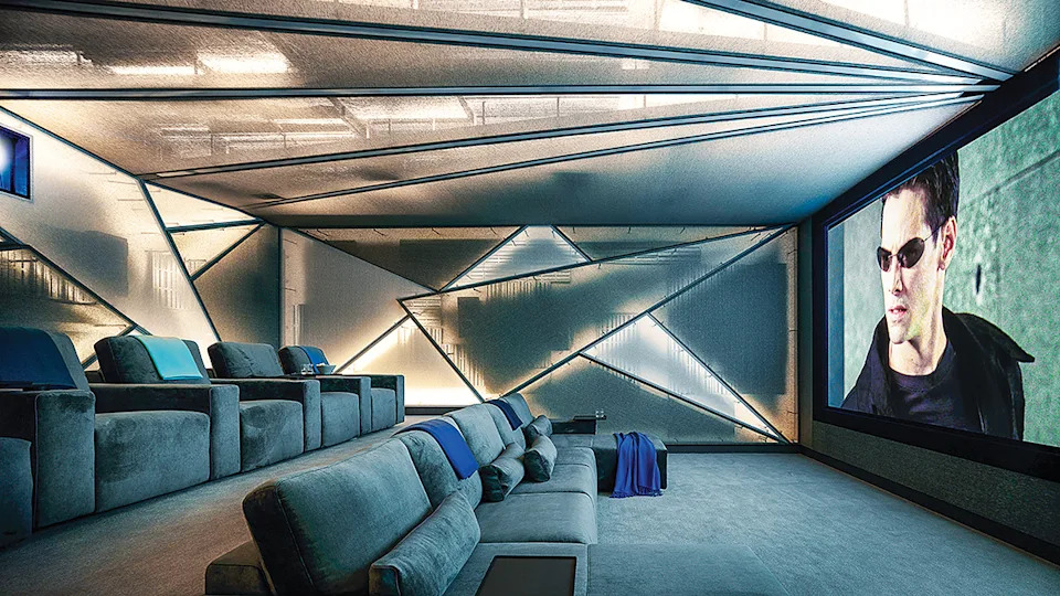 Custom two-tone wall upholstery decorating the triangular forms on the home-theater walls.