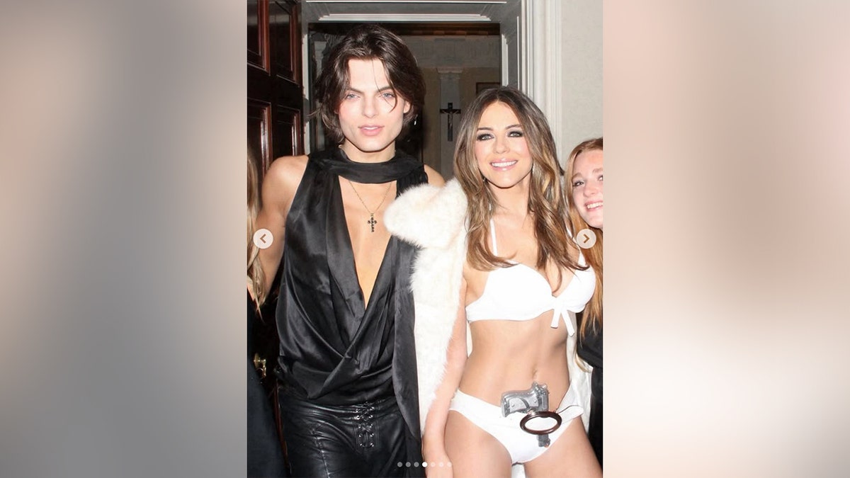 Hurley posed with her son who was in leather pants and a plunging blouse.